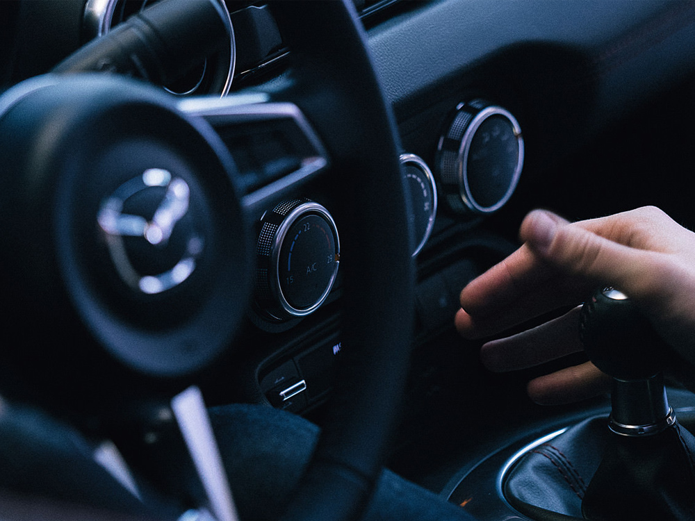Cockpit closeup view of hand on shifter. 