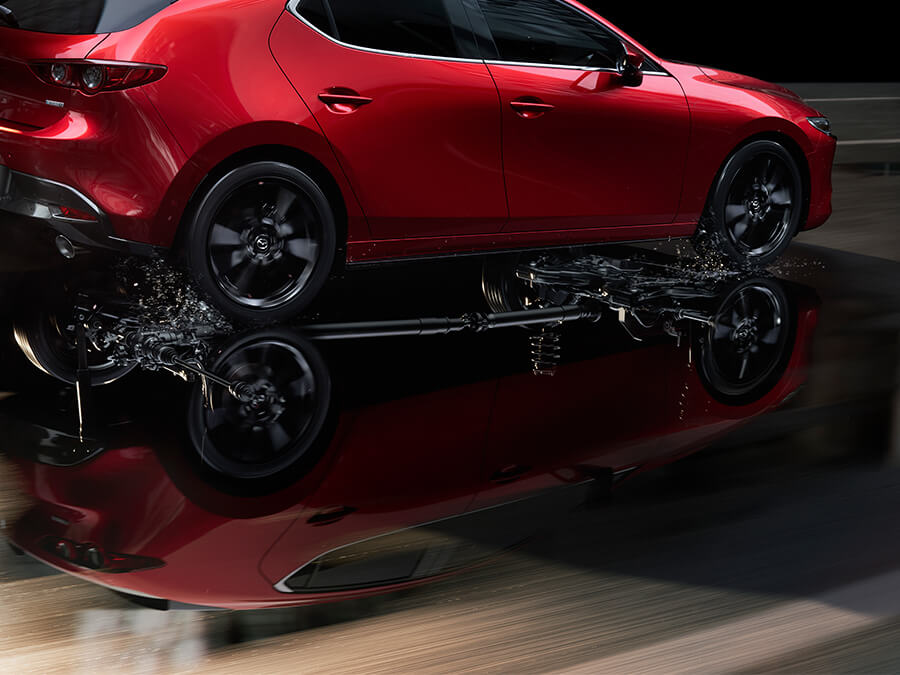 Red Mazda CX-5 moving straight on road