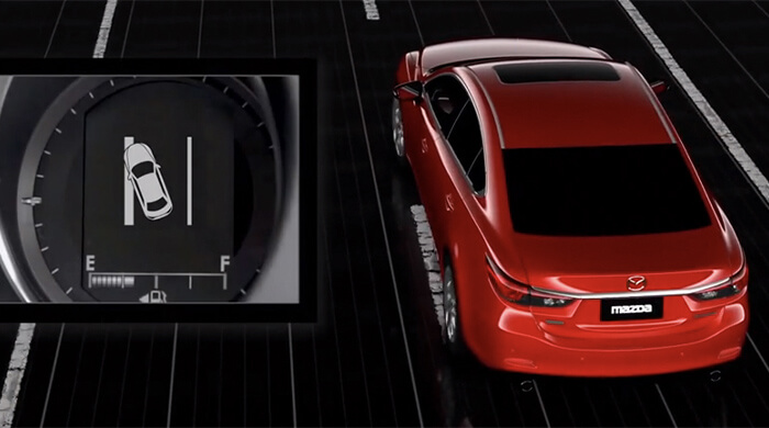 Red Mazda gets alerted as it accidentally crosses into the next lane