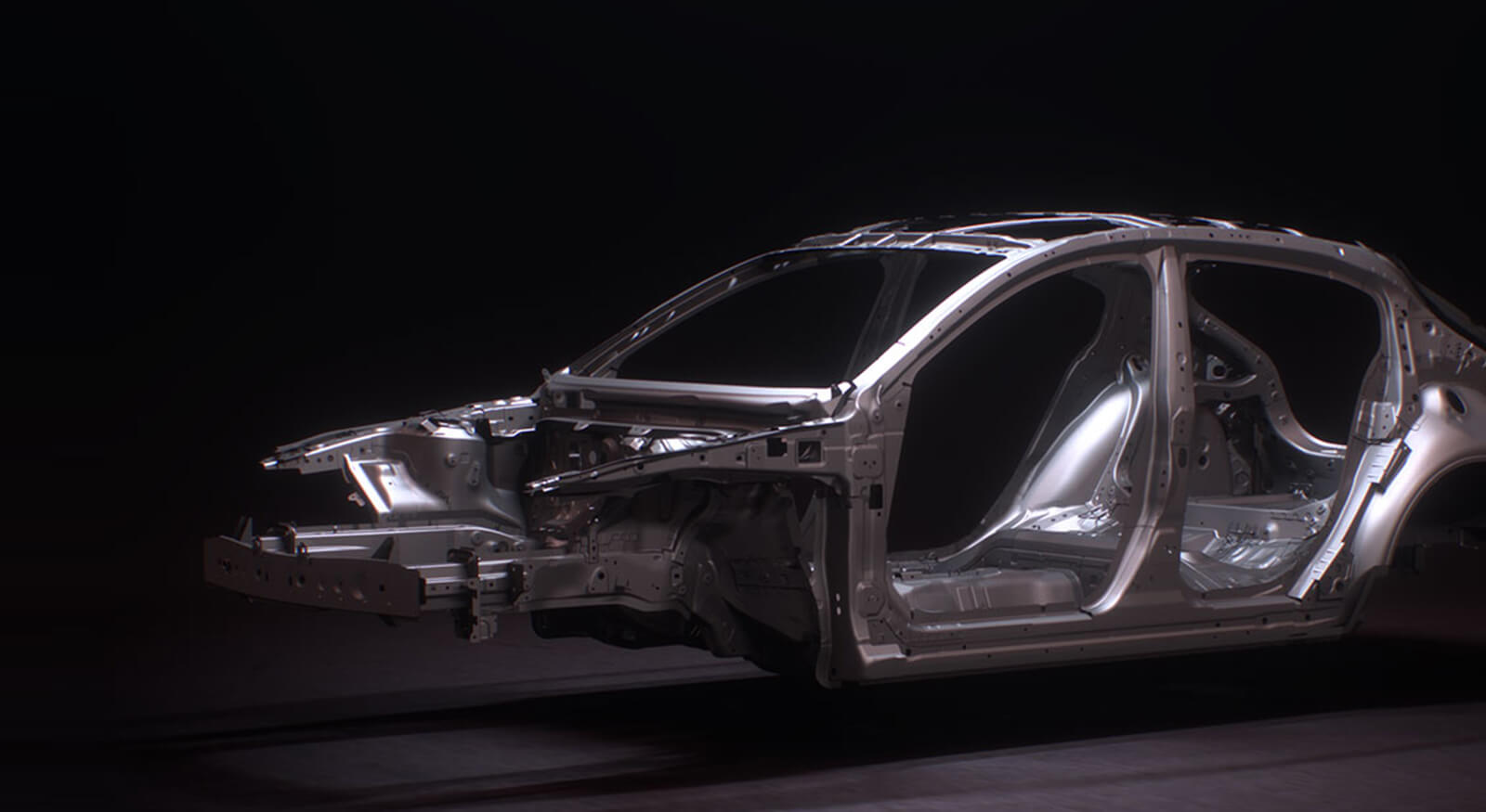 Steel vehicle frame gleams against black background.