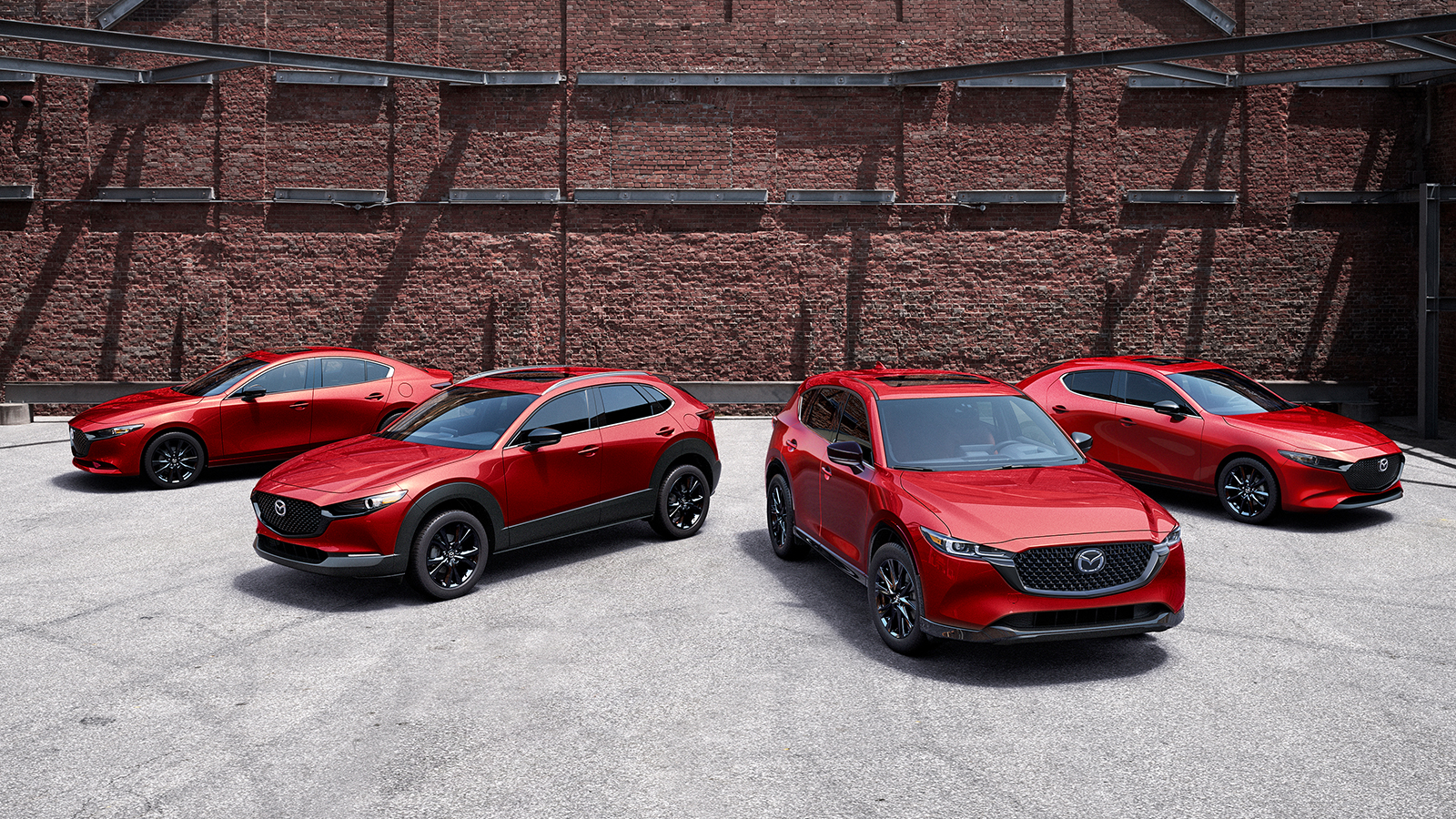 Mazda models on showroom floor featuring the Mazda3 sedan, Mazda6 and the CX-5.