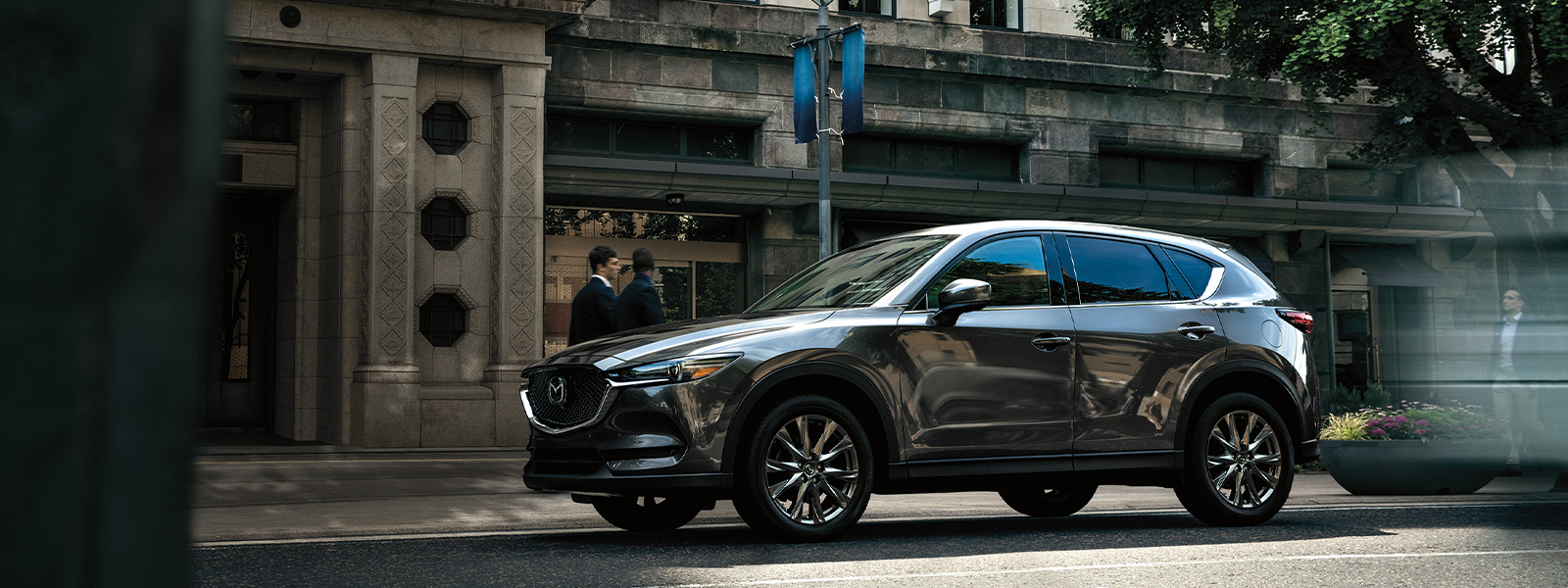 Deep crystal blue mica CX-5 parked on urban street.