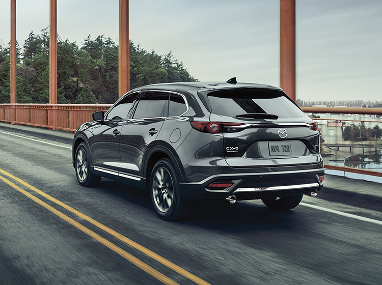 Sonic Silver Metallic Mazda CX-9 driving across bridge.