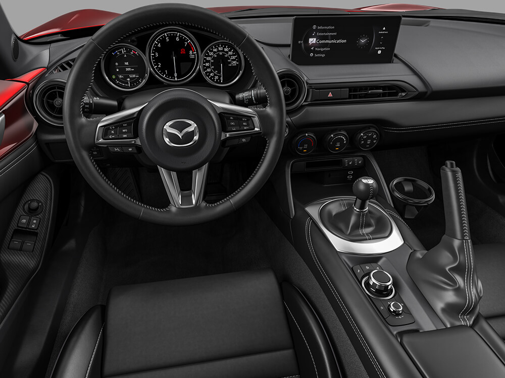 View of the interior cabin of an MX-5 RF with steering wheel and dashboard. 