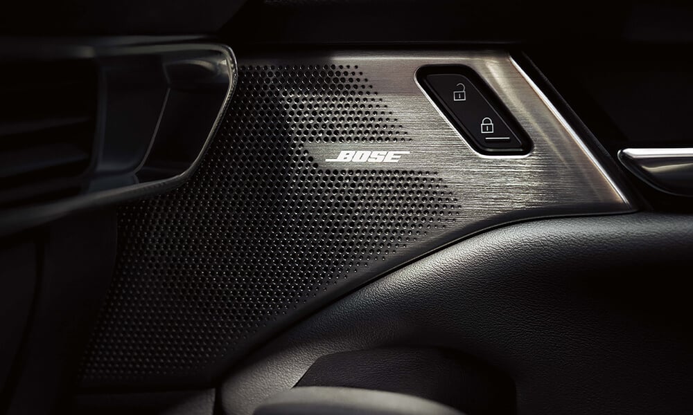 Close-up of the Mazda3 Sport interior door panel highlighting the Bose speaker.